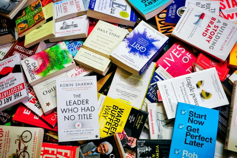 assorted collection of books with different sizes=